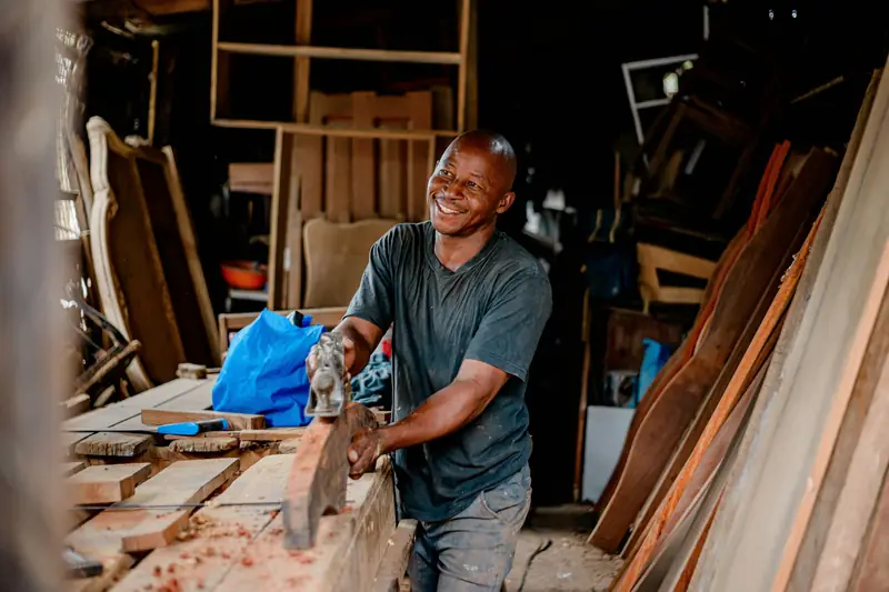 Woodworker smiling in a workshop