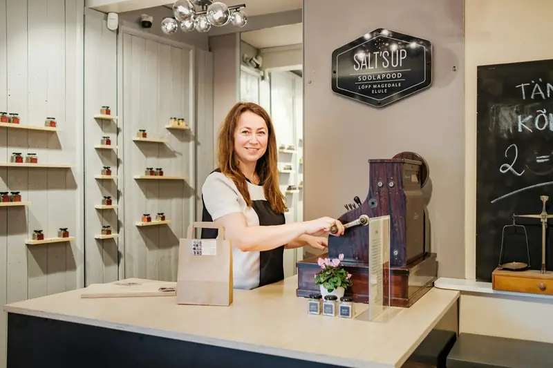 Shop owner arranging products in her store
